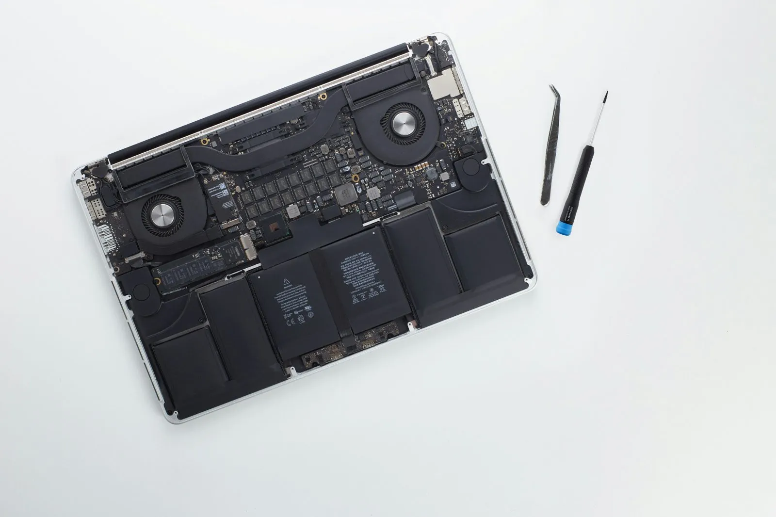 Laptop open on a workbench during testing